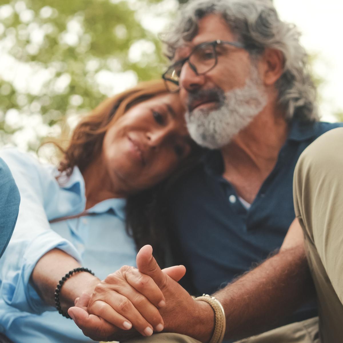 Older Couple Hug with Clasped Hands